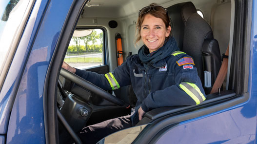 An MPC driver shown in the driver seat smiling