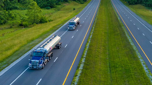 Two MPC trucks driving on the freeway