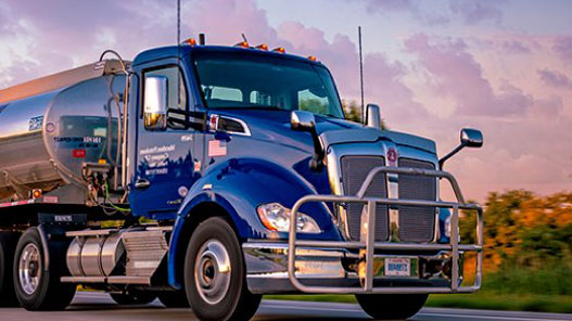 A photo of the front cabin of an MPC truck driving on the road